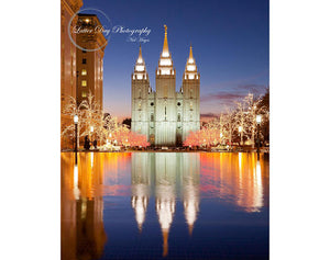 A beautiful image of the Salt Lake City Temple lit up and reflected at Christmas time.