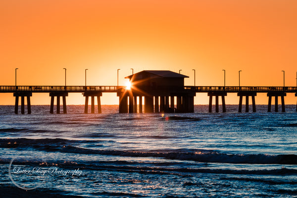 Original fine art photography of the sun setting over the ocean and behind the pier in Gulf Shores Alabama!